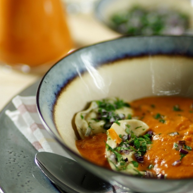 Creamy tomato soup with basil-mozzarella ravioli