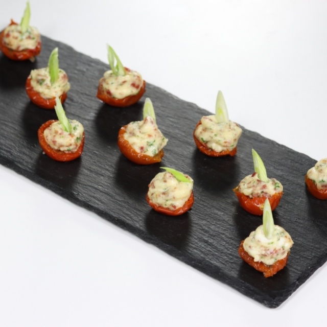 Cherry tomatoes stuffed with Parma ham and Pecorino cream